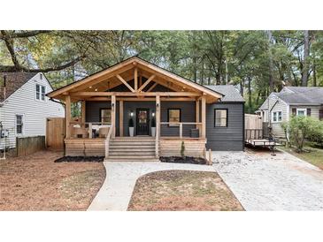 Charming home with a large, inviting covered front porch, steps, and walkway leading to the front door at 410 Wilkinson Se Dr, Atlanta, GA 30317