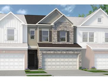 Charming townhome showcasing stone accents, a two-car garage, and a welcoming front entrance at 20 Jacobs Farm Ln # 10, Lawrenceville, GA 30045