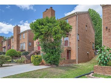Charming brick townhouse with well-maintained landscaping and inviting entrance, perfect for comfortable living at 91 Davis Mill Ct, Lawrenceville, GA 30044
