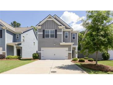Charming two-story home with gray siding, a two-car garage, and well-maintained landscaping at 156 Woodhouse Cir, Acworth, GA 30102