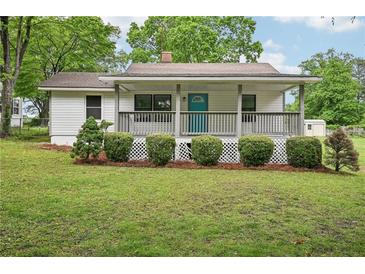 Charming single-story home with a welcoming front porch and well-maintained lawn at 6648 Florence Dr, Lithia Springs, GA 30122