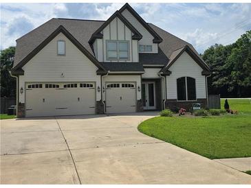 Charming two-story home featuring a three car garage, manicured lawn, and craftsman style architecture at 3000 Keeneland Blvd, Mcdonough, GA 30252