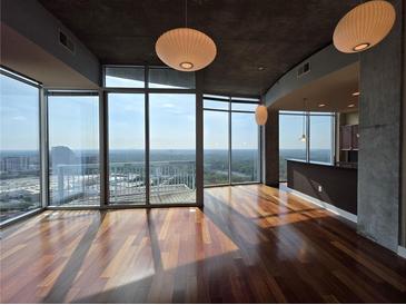 Bright living room featuring hardwood floors, floor to ceiling windows and spectacular views at 3324 Peachtree Ne Rd # 3001, Atlanta, GA 30326