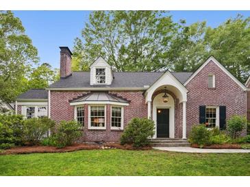 Charming red brick two-story home with manicured lawn and beautiful landscaping at 2672 Birchwood Dr, Atlanta, GA 30305