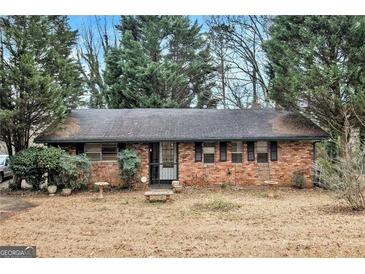 Charming single-story brick home with a well-maintained front yard and mature trees at 1491 Boulderwoods Dr, Atlanta, GA 30316