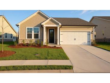 Beautiful single-story home with a well-maintained lawn and attached two car garage at 1783 Juniper Berry Way, Loganville, GA 30052