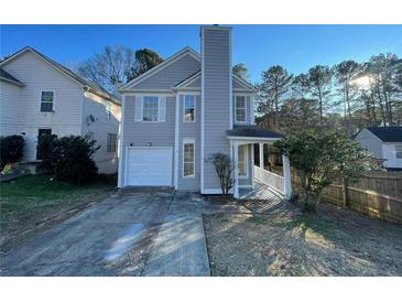 Charming two-story home featuring a covered front porch, attached garage and manicured lawn at 3210 Linden Dr, Lawrenceville, GA 30044