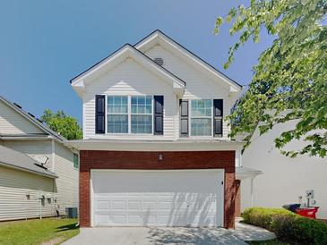 Charming two-story home featuring brick accents and a well-maintained front yard at 2429 Wood Bend Ln, Riverdale, GA 30296