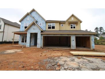 Two-story home under construction featuring a two-car garage and covered porch awaiting its finishing touches at 452 Maypop Ln, Woodstock, GA 30188