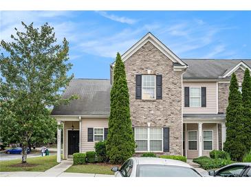Attractive townhome exterior with brick accents, black shutters, and neat landscaping at 2555 Flat Shoals Rd # 801, Atlanta, GA 30349