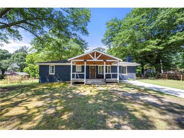 Charming home featuring a covered porch and well-maintained lawn at 3770 Ponderosa Ln, Powder Springs, GA 30127
