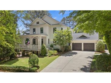 Charming two-story home with a welcoming front porch and manicured landscaping at 4495 Westgate Dr, Cumming, GA 30040