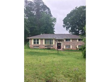 Charming brick ranch home with a well-manicured lawn and mature trees providing ample shade at 4961 Ivey Road, Acworth, GA 30101