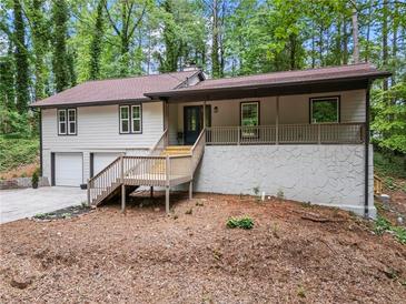 Charming two-story home boasts a welcoming front porch and a two-car garage at 641 Charing Cross Dr, Marietta, GA 30066