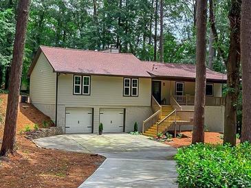 Charming ranch-style home featuring a two-car garage, stone accents, and a welcoming front porch at 641 Charing Cross Dr, Marietta, GA 30066