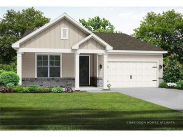Charming single-story home with a well-manicured lawn and attached two-car garage at 3564 Arrow Root Cir, Loganville, GA 30052
