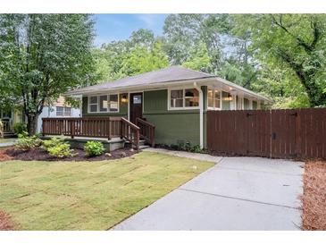 Charming home with a manicured lawn, inviting porch, and lush landscaping at 1142 Palafox Ne Dr, Atlanta, GA 30324