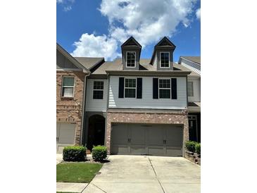 Charming townhome with a two-car garage and manicured landscaping at 2249 Knoxhill Se Vw, Smyrna, GA 30082