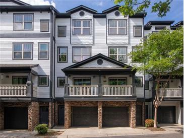 Charming townhouse with a private balcony, stone accents, and a two-car garage at 221 Semel Nw Dr # 273, Atlanta, GA 30309