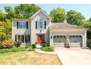 Charming two-story home with a well-maintained front yard, attached two-car garage, and a vibrant red front door at 515 Rosedown Way, Lawrenceville, GA 30043