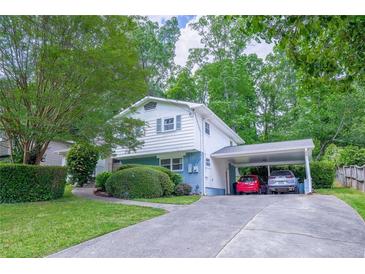 Charming two-story home with a carport and well-maintained landscaping creating a welcoming curb appeal at 2592 Dresden Dr, Atlanta, GA 30341