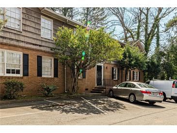 Charming brick building featuring ample parking and mature trees in a landscaped surrounding at 3626 Buford Ne Hwy # C2, Brookhaven, GA 30329