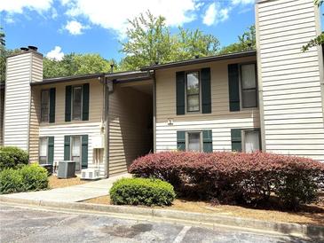 Charming two-story condo with green shutters and well-maintained landscaping at 9400 Roberts Dr # 7M, Atlanta, GA 30350