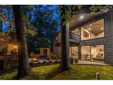 Striking two-story home with modern design, floor to ceiling windows, and an inviting outdoor living space at 4052 Loch Highland Ne Pass, Roswell, GA 30075
