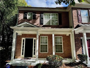 Charming brick townhouse with a welcoming front porch and classic architectural details at 4842 Hairston Park Sq, Stone Mountain, GA 30083