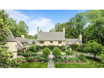 Stately home boasts manicured landscaping, blooming flowers, and mature trees for ultimate curb appeal at 675 W Paces Ferry Nw Rd # 11, Atlanta, GA 30327