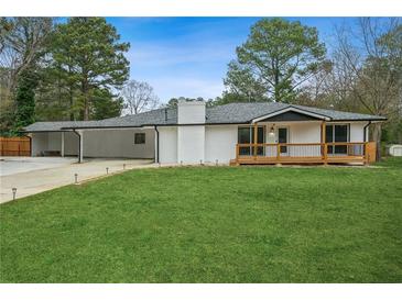 Charming one-story home with a well-maintained lawn, covered porch, and spacious carport at 4166 Idlevale Dr, Tucker, GA 30084