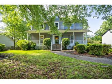 Charming two-story home featuring a welcoming front porch and well-manicured landscaping at 1491 Kolb Ridge Sw Dr, Marietta, GA 30008