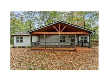 Charming home featuring a covered porch with wood beams and ample natural light and an inviting entrance at 2205 Stockbridge Se Dr, Atlanta, GA 30316