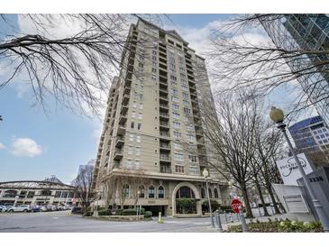 An exterior shot of a large building with street signage under a partly cloudy blue sky at 3334 Peachtree Ne Rd # 101, Atlanta, GA 30326
