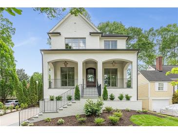 Beautiful two-story painted brick home with a manicured front yard and covered front porch at 1211 Reeder Ne Cir, Atlanta, GA 30306