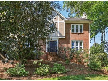 Charming two-story home with a combination brick and stucco facade, featuring a landscaped front yard at 3298 Robinson Oaks Ne Way, Marietta, GA 30062