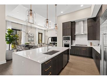 Modern kitchen featuring a large island, stainless steel appliances, and stylish pendant lighting at 40 12Th Ne St # 1704, Atlanta, GA 30309