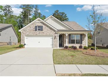 Charming single-story brick home with a two-car garage, well-kept lawn and inviting curb appeal at 3382 Long Creek Dr, Buford, GA 30519
