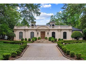 Elegant home featuring a symmetrical facade, manicured landscaping, and a grand driveway leading to the entrance at 3212 Arden Nw Rd, Atlanta, GA 30305