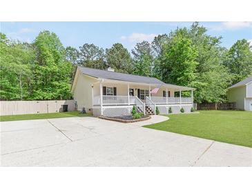 Charming home with covered porch, landscaped front, and driveway at 37 Winesap Ct, Temple, GA 30179