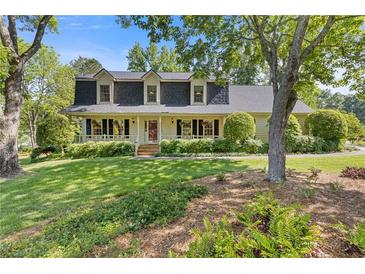 Charming home with a welcoming front porch and beautifully landscaped front yard at 3527 Starwood Sw Trl, Lilburn, GA 30047