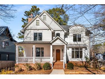 Inviting two-story home featuring a brick front porch and classic white siding at 1271 Fenway Cir, Decatur, GA 30030