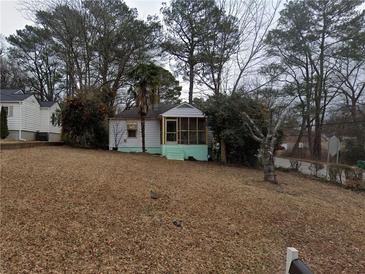 Charming home featuring a screened porch, surrounded by mature trees and an expansive front yard at 2010 Mcafee Pl, Decatur, GA 30032