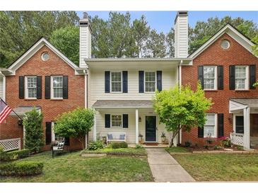 Charming townhome with brick accents, a manicured lawn and beautiful landscaping at 3992 Camden Way, Alpharetta, GA 30005