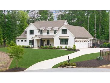 Stunning two-story home with a manicured lawn and elegant white facade at 604 Trinity Church Rd, Canton, GA 30115