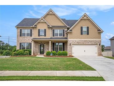 Beautiful two-story brick home with well-manicured lawn and attached two car garage at 113 Osier Dr, Mcdonough, GA 30252