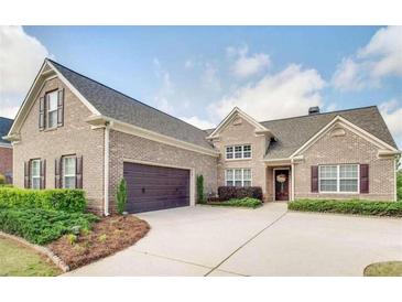 Charming brick home featuring manicured landscaping, a two-car garage, and a welcoming front entrance at 4217 Brentwood Dr, Buford, GA 30518