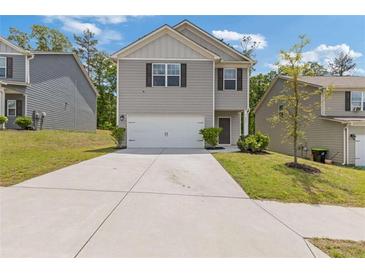Charming two-story home featuring gray siding, a two-car garage, and a well-manicured front yard at 3475 Ridge Hill Pkwy, Douglasville, GA 30135