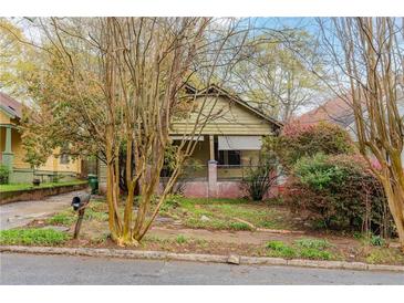 Charming home with a covered porch and mature trees in the front yard at 1388 Metropolitan Se Ave, Atlanta, GA 30316