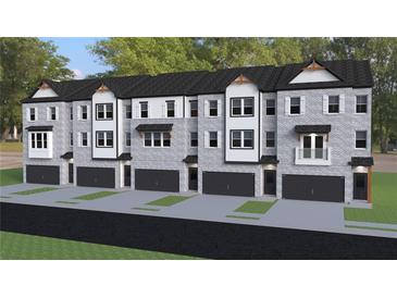 Modern townhomes featuring gray brick, black accents, individual garages, and manicured lawns at 2 Rock Park Way # 13, Tucker, GA 30084